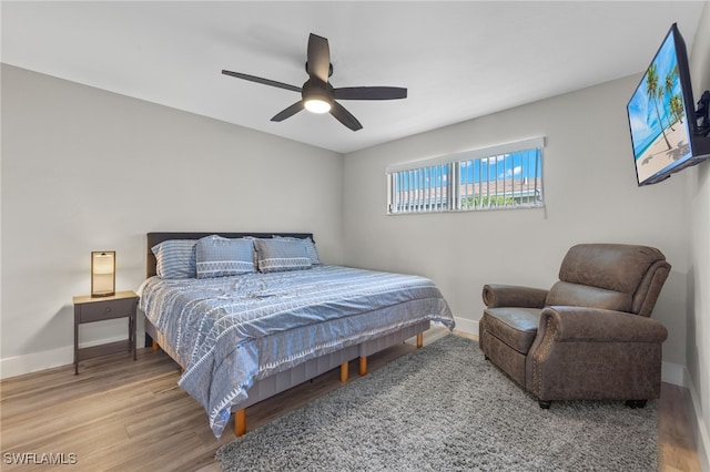 bedroom with wood-type flooring and ceiling fan