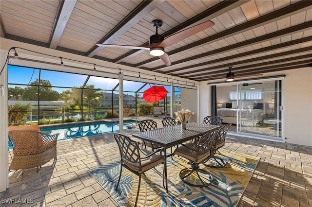 view of patio featuring ceiling fan and a lanai