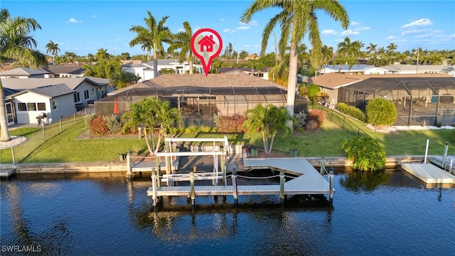 dock area with a water view, a yard, and glass enclosure