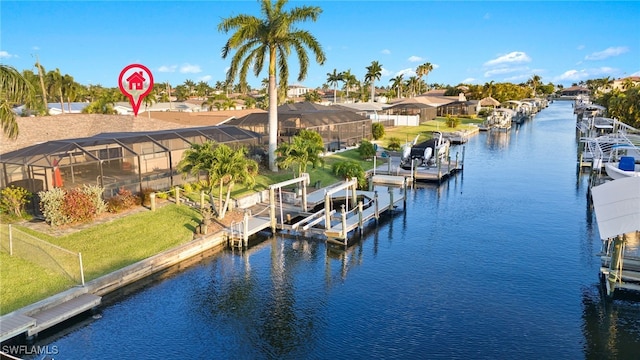 dock area featuring a lawn, a water view, and glass enclosure