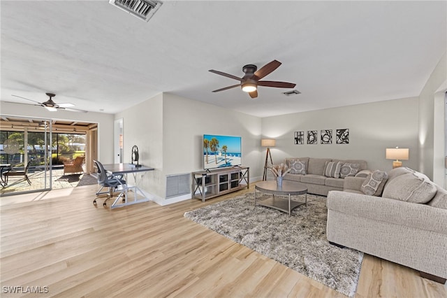 living room featuring wood-type flooring and ceiling fan