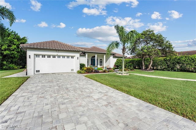 mediterranean / spanish house with a garage and a front lawn