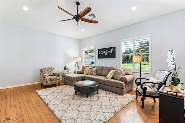 living room with ceiling fan, hardwood / wood-style flooring, and plenty of natural light