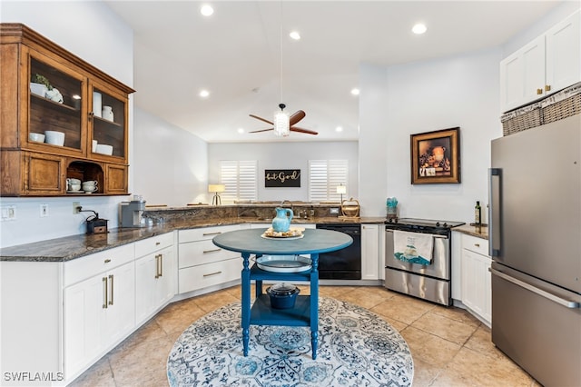 kitchen featuring white cabinetry, kitchen peninsula, appliances with stainless steel finishes, dark stone countertops, and ceiling fan