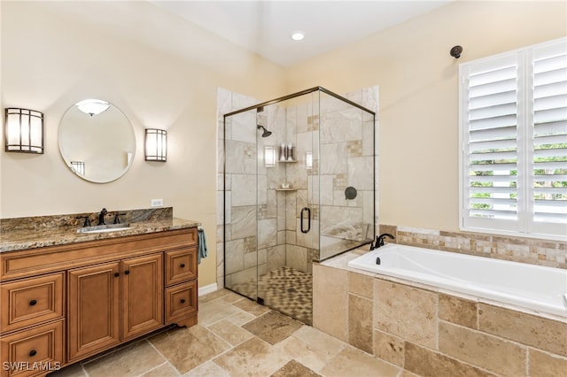 bathroom featuring independent shower and bath and vanity