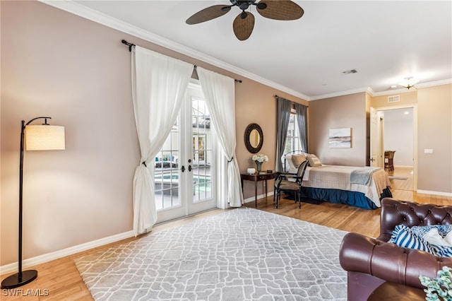 bedroom featuring wood-type flooring, access to outside, ornamental molding, ceiling fan, and french doors