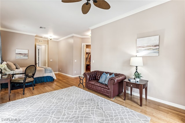 living room with wood-type flooring, ornamental molding, and ceiling fan