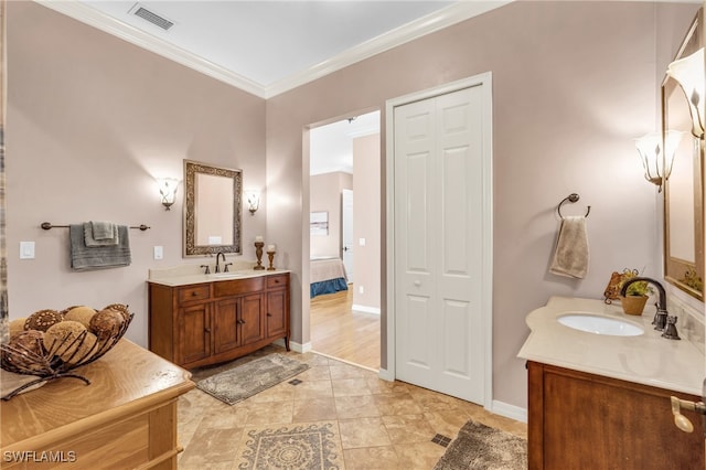 bathroom featuring tile patterned flooring, vanity, and crown molding