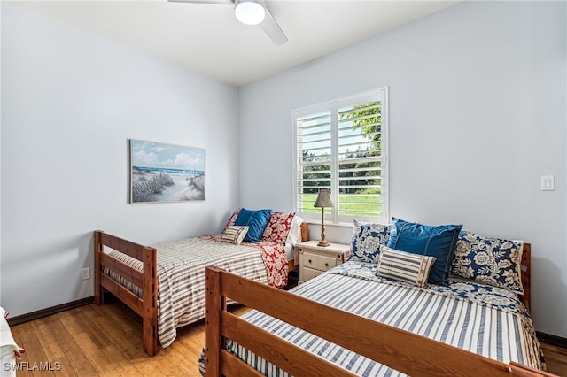 bedroom with light hardwood / wood-style floors and ceiling fan