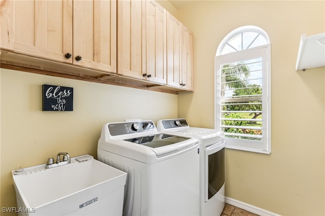 laundry area with sink, independent washer and dryer, tile patterned floors, and cabinets