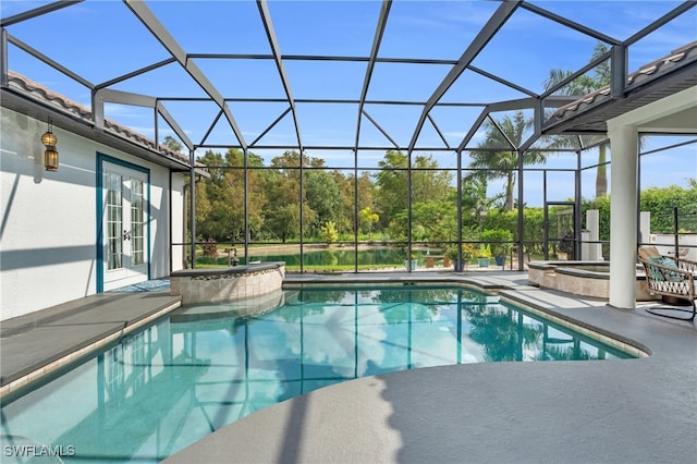 view of pool with french doors, a patio, a jacuzzi, and a lanai