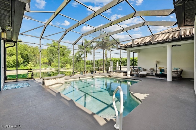 view of pool featuring glass enclosure and a patio