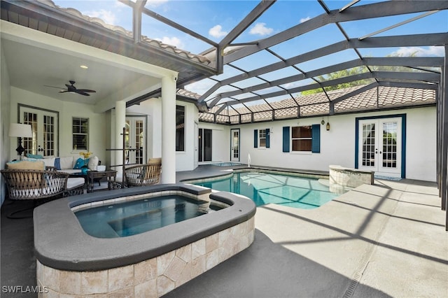 view of pool featuring a patio, an in ground hot tub, glass enclosure, ceiling fan, and french doors