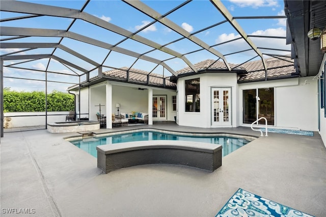 view of swimming pool with an in ground hot tub, a lanai, ceiling fan, and a patio area