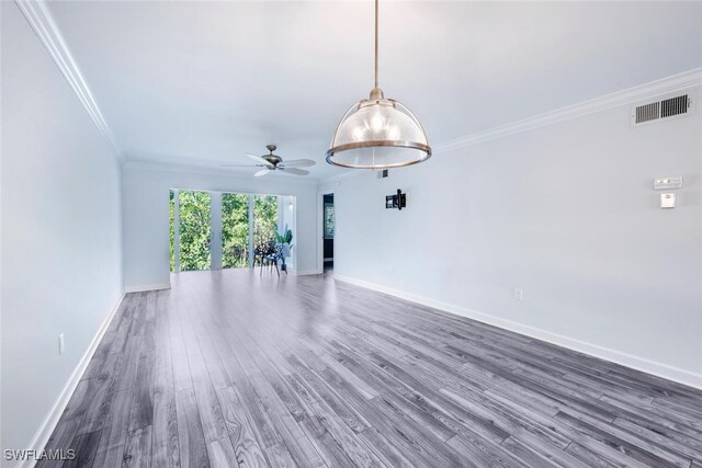 unfurnished room with crown molding, ceiling fan, and dark hardwood / wood-style flooring