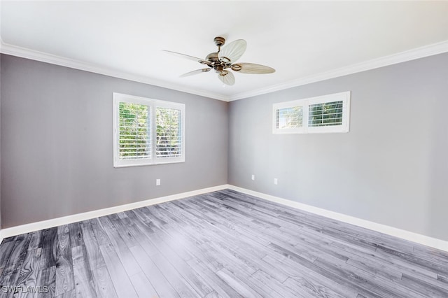 empty room with ornamental molding, light hardwood / wood-style floors, and ceiling fan