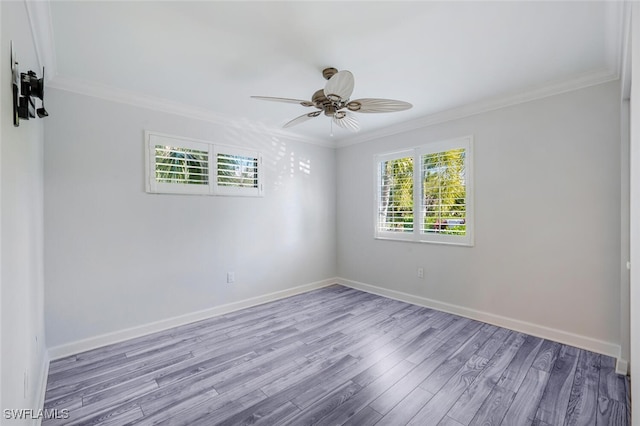 empty room with crown molding, ceiling fan, and light hardwood / wood-style flooring