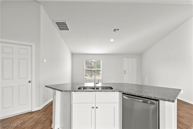 kitchen featuring sink, a center island with sink, hardwood / wood-style flooring, dishwasher, and white cabinetry