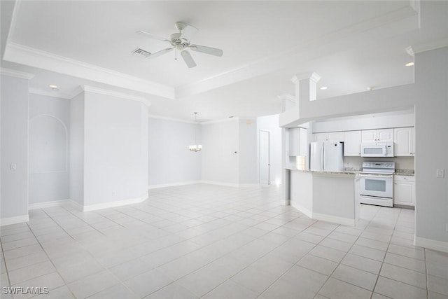 kitchen with white appliances, a tray ceiling, open floor plan, and ceiling fan with notable chandelier