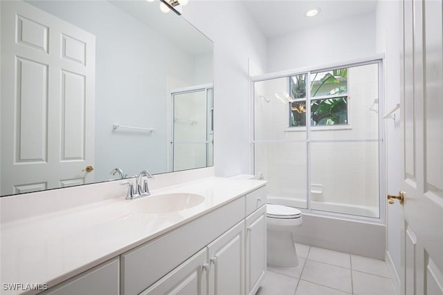 full bathroom featuring toilet, shower / bath combination with glass door, vanity, and tile patterned floors