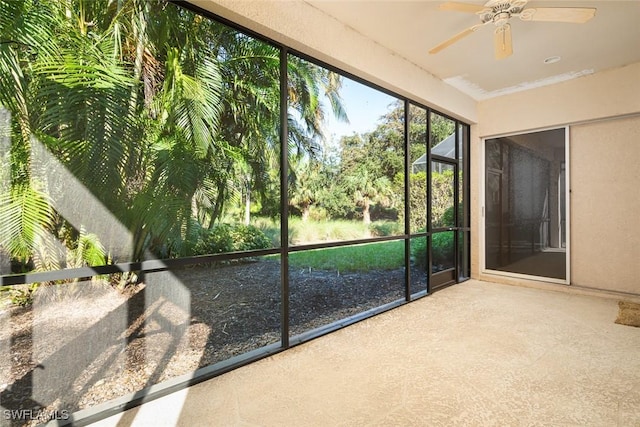 unfurnished sunroom with a ceiling fan