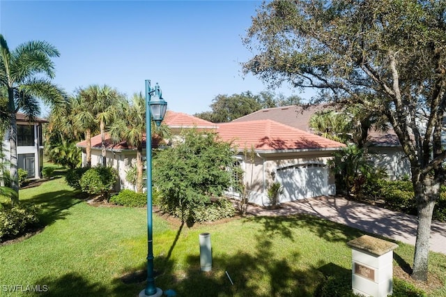 view of front of house featuring a tile roof, driveway, and a front lawn