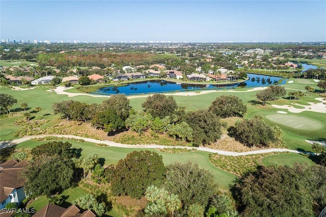 birds eye view of property with a water view and golf course view