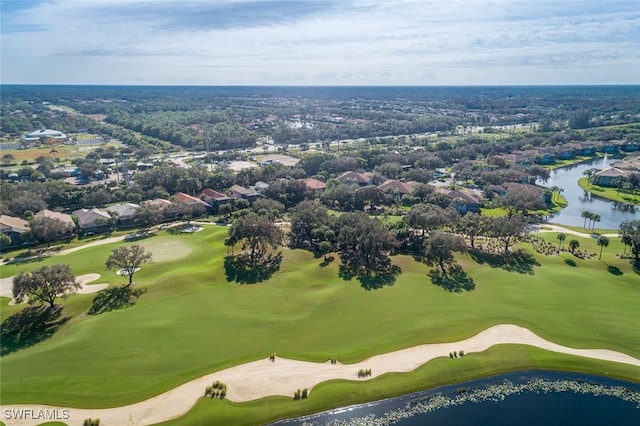 drone / aerial view featuring golf course view and a water view