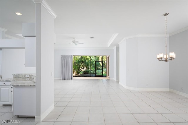 empty room featuring light tile patterned floors, ornamental molding, ceiling fan with notable chandelier, and baseboards