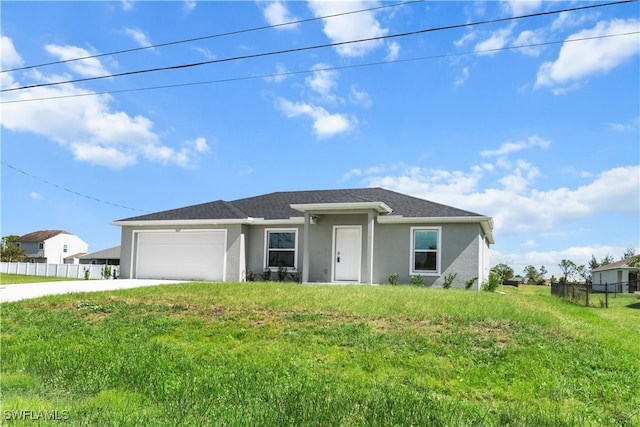 view of front of property with a front yard and a garage