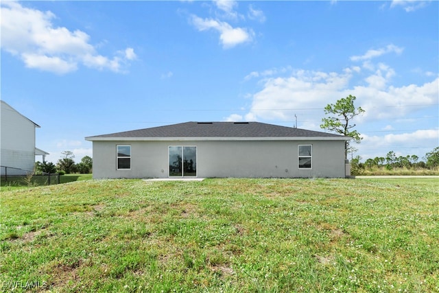 back of house with a lawn