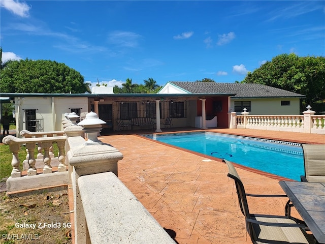 view of swimming pool with a patio