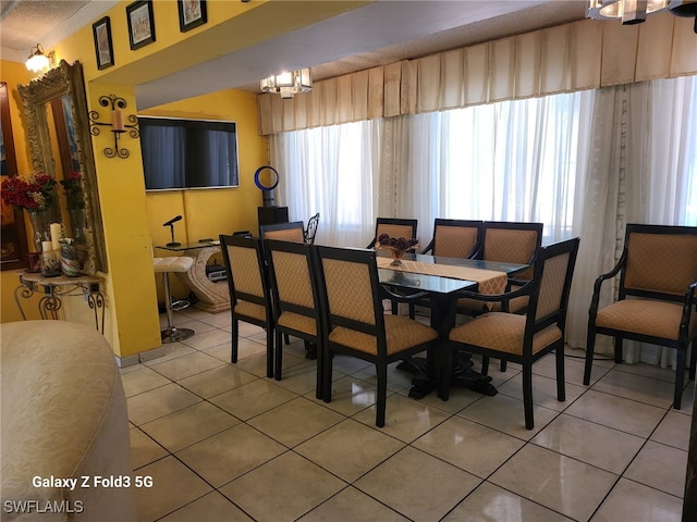 dining space with an inviting chandelier and tile patterned floors