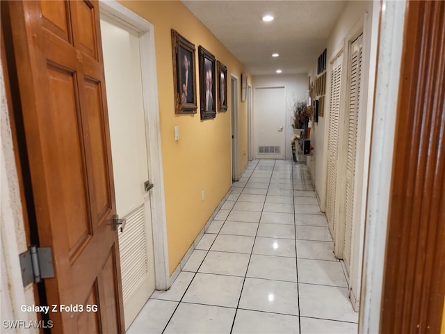 corridor featuring light tile patterned floors