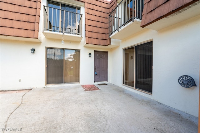 doorway to property with a patio area