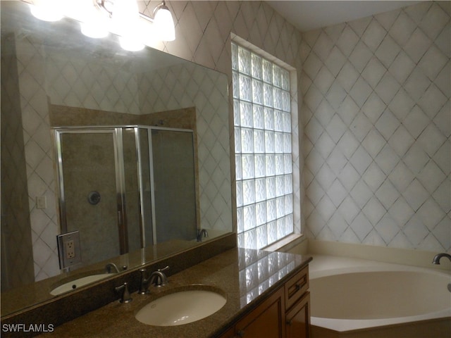 bathroom featuring vanity and separate shower and tub