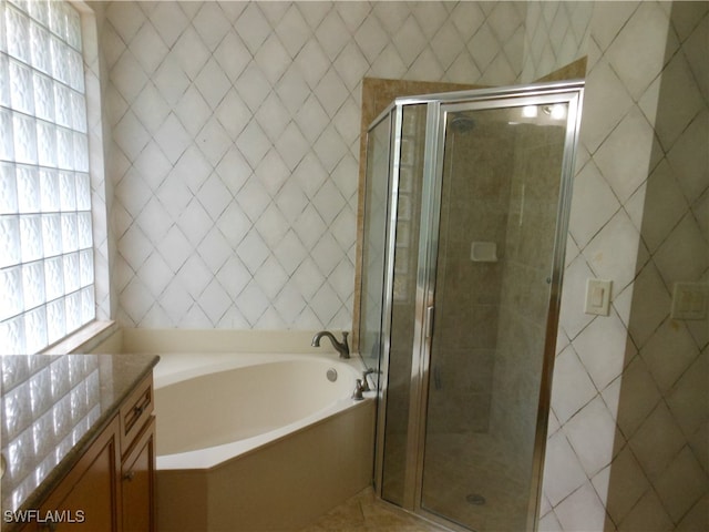 bathroom featuring vanity and shower with separate bathtub