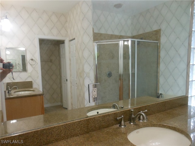 bathroom with vanity and a shower with shower door