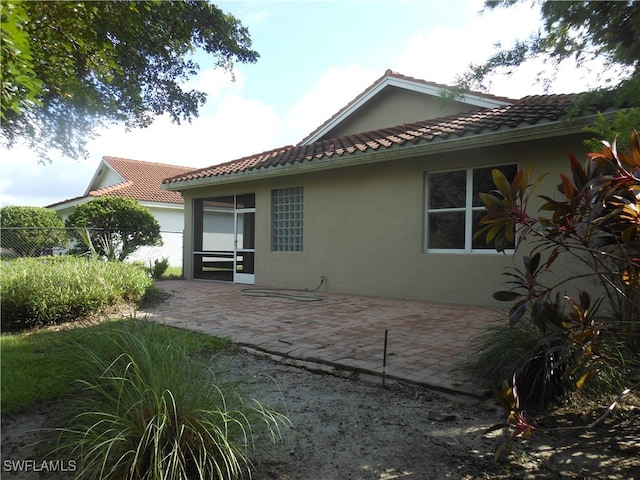 rear view of property featuring a patio area