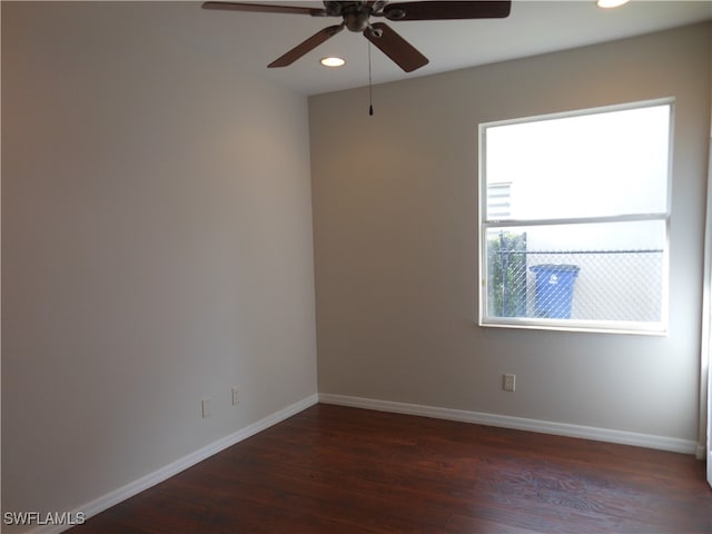 unfurnished room featuring ceiling fan and dark wood-type flooring