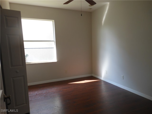 unfurnished room featuring ceiling fan, a healthy amount of sunlight, and dark hardwood / wood-style flooring