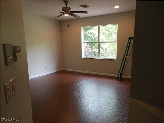 unfurnished room with ceiling fan and dark wood-type flooring