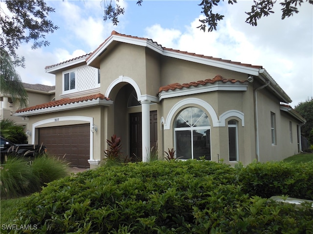 mediterranean / spanish-style house featuring a garage