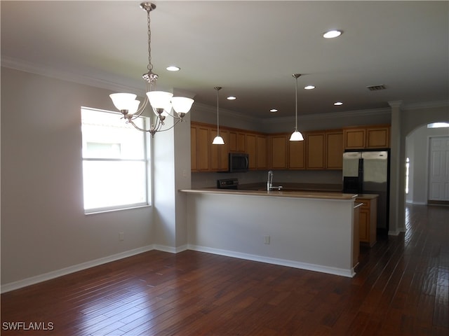 kitchen with crown molding, dark hardwood / wood-style flooring, and pendant lighting