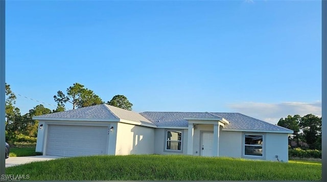 917 Martha Ave S, Lehigh Acres, FL 33974 - ranch-style house with a garage, stucco siding, a front lawn, concrete driveway, and a shingled roof