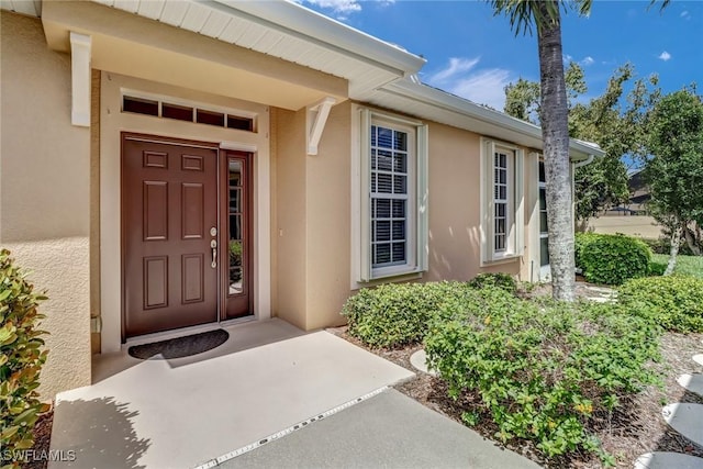 property entrance with stucco siding