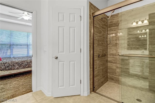 full bathroom featuring a shower stall, a ceiling fan, tile patterned flooring, ensuite bathroom, and baseboards