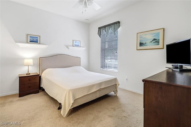 bedroom featuring light carpet, baseboards, and a ceiling fan