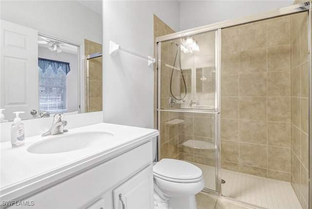 full bathroom featuring toilet, tile patterned floors, a shower stall, and vanity