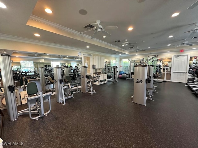 exercise room with ceiling fan, a tray ceiling, crown molding, and recessed lighting